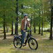 Man riding an Freego City Flow A1 Electric Bike in a park with trees in the background