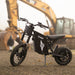 Side profile of Freego X0 black electric mini bike standing in front of heavy construction machinery.